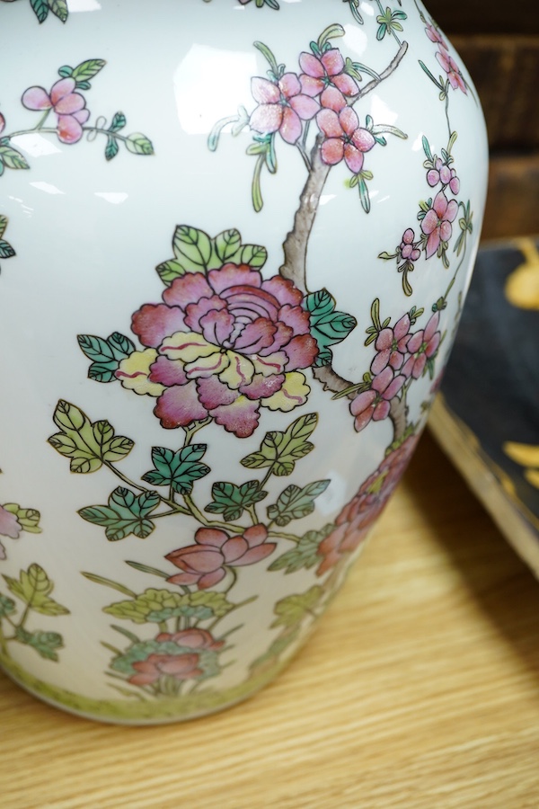A pair of Chinese famille rose baluster vases decorated with flowers, 36cm high